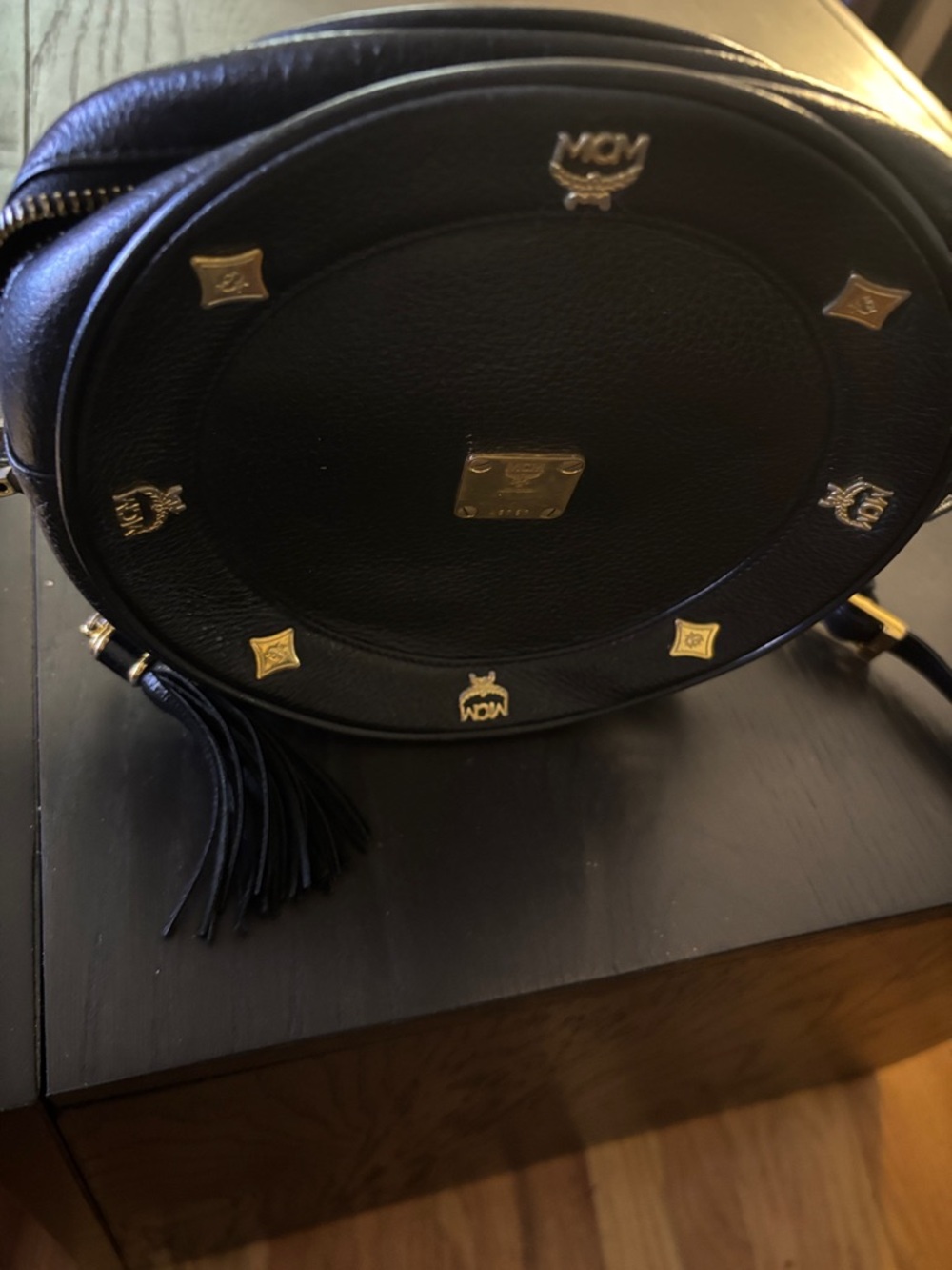 MCM Black Leather Round Crossbody with Gold Accents and Tassel